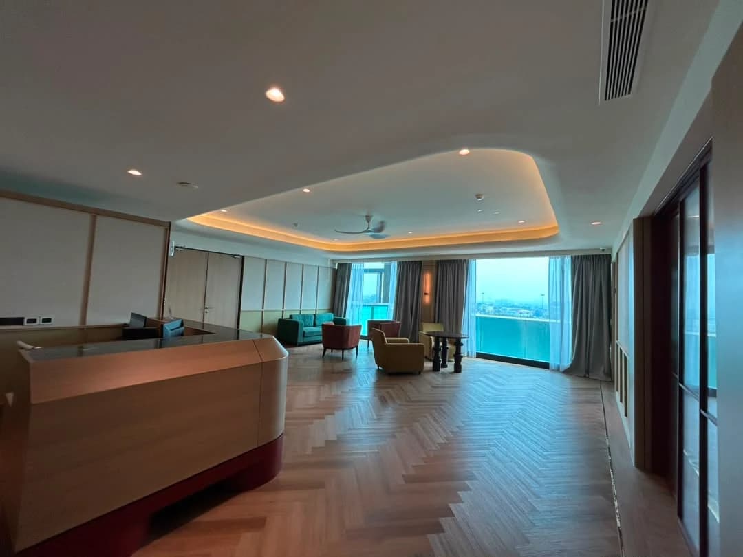 A common lounge with sofas and floor-to-ceiling windows