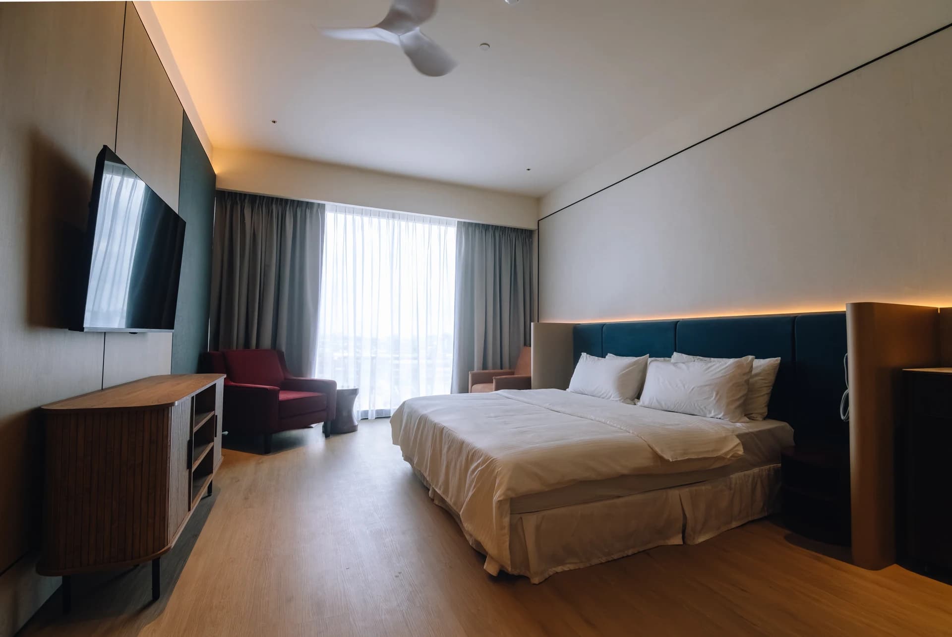 A king room with a TV wall and a window